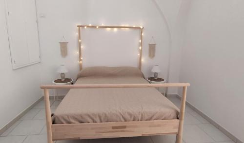 a bed with lights on it in a room at Appartamenti Boho Chic in Sannicandro di Bari