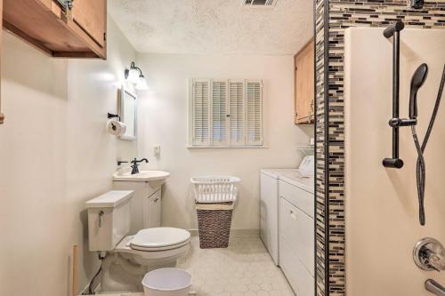 a white bathroom with a toilet and a sink at Lakefront Macon Getaway Grill, Pet Friendly! in Macon