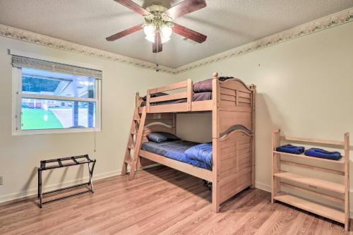a bedroom with bunk beds and a ceiling fan at Lakefront Macon Getaway Grill, Pet Friendly! in Macon