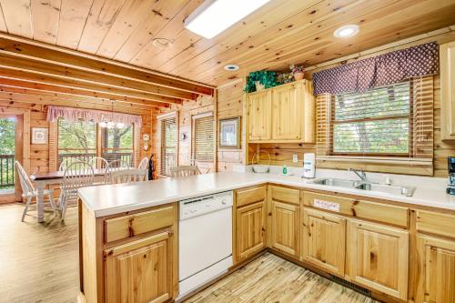 a kitchen with wooden cabinetry and a dining room at Almost Heaven in Pigeon Forge