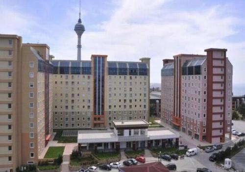 a view of a city with tall buildings and a tower at FATIH - TUYAP APART'S in Kırac