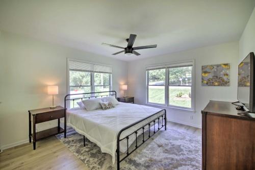 a bedroom with a bed and a ceiling fan at Modern Eckerty Home with Deck on Patoka Lake! in Taswell