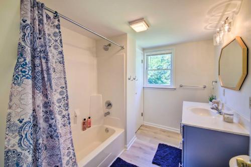 a bathroom with a tub and a sink and a shower at Modern Eckerty Home with Deck on Patoka Lake! in Taswell
