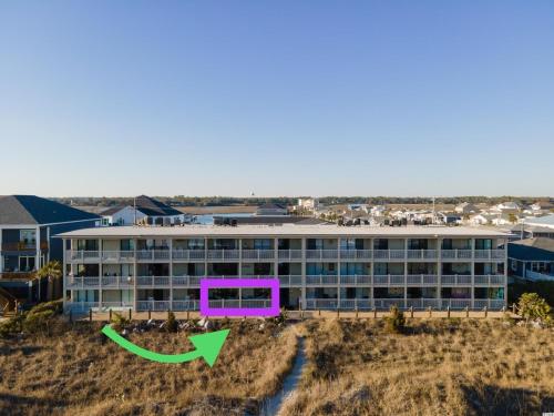 an aerial view of a building with a green arrow at BEAUTIFUL BEACHFRONT-Oceanfront First Floor 2BR 2BA Condo in Cherry Grove, North Myrtle Beach! RENOVATED with a Fully Equipped Kitchen, 3 Separate Beds, Pool, Private Patio & Steps to the Sand! in Myrtle Beach