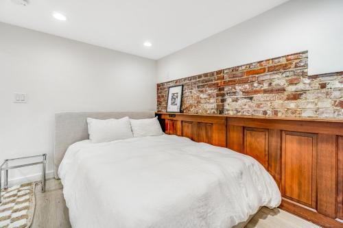 Un dormitorio con una pared de ladrillo y una cama en The Studio en Seattle