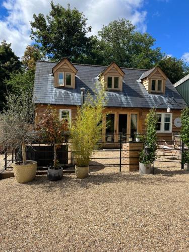 a house with potted plants in front of it at Winterberry Barn in Romsey