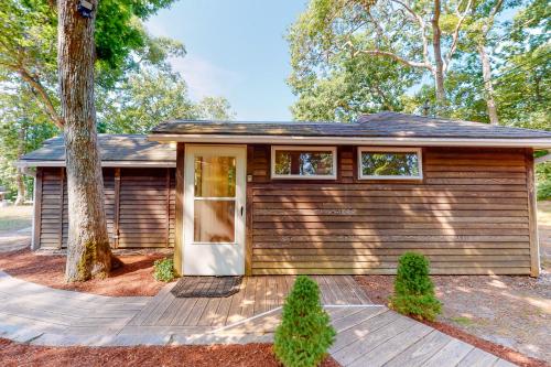 a small house with a tree in front of it at Sea House in Chatham