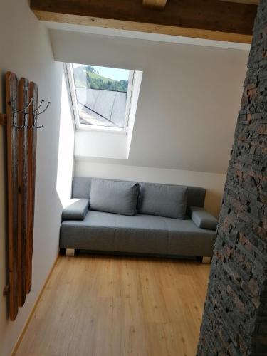 a blue couch in a room with a window at Appartment Romy in Radstadt
