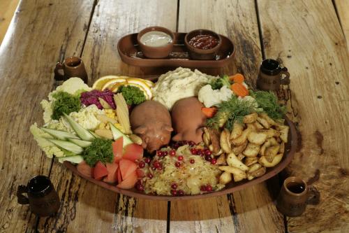 a plate of food on a wooden table at Viikingite küla in Saula