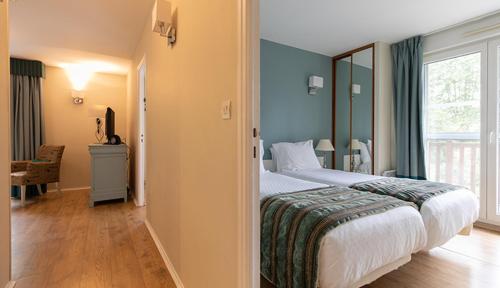 a hotel room with a bed and a window at Club Wyndham Normandy in Connelles