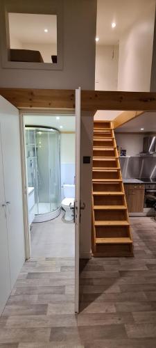 a bathroom with a staircase in a house at L'Epinette - Gîte de groupe et salle de réception in Allevard
