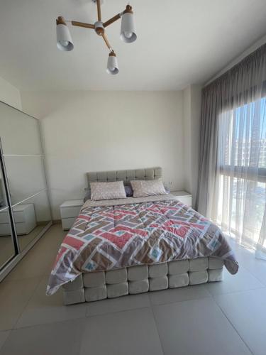 a bedroom with a large bed in a white room at Elegant 1BR Chalet at Marassi Marina 2 in El Alamein
