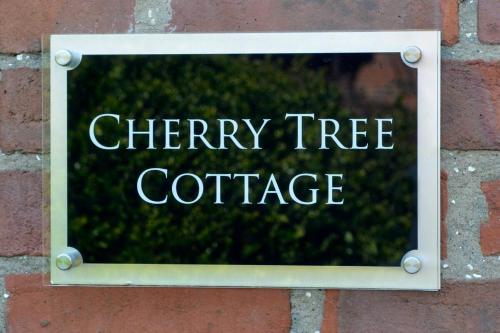a sign on a brick wall that reads cherry tree coffee at Cherry Tree Cottage in Bempton