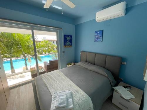 a bedroom with a bed with a view of a pool at Boca Paraiso in Boca Chica