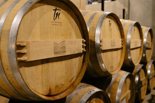 a row of wine barrels in a cellar at Estancias Sierravita in Valle de Guadalupe