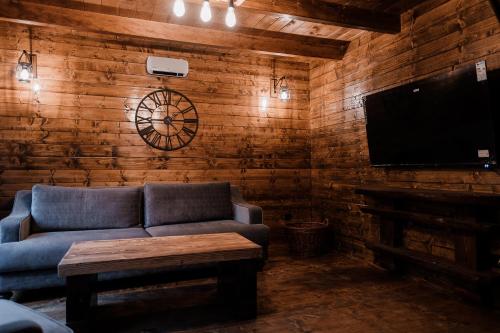 a living room with a couch and a flat screen tv at Black River in Kolašin