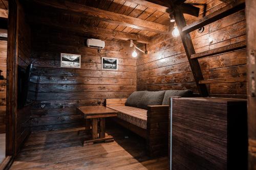 a room with a bench in a wooden cabin at Black River in Kolašin