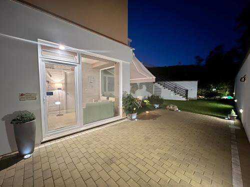 a patio with a large sliding glass door at B&B SANGIORGIO Green living in Melpignano