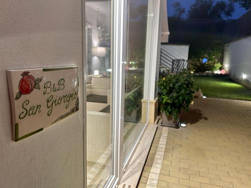 a sign on the door of a house that says be a san superstar at B&B SANGIORGIO Green living in Melpignano