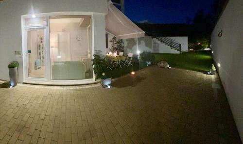 a house with a patio with a table and chairs at B&B SANGIORGIO Green living in Melpignano