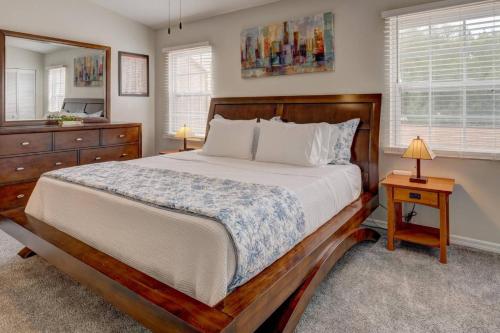 a bedroom with a bed and a dresser and a mirror at Getaway to iki Tampa is an End Unit Townhome - Close to Tampa Bay & Downtown - Minutes to Airport in Tampa