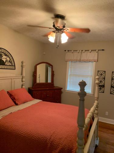 a bedroom with a bed and a ceiling fan at Serene 6BR country home on 325 acres ATV for rent in Burgettstown