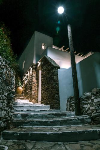 a building with a street light next to stairs at night at Agapi Home in Agápi