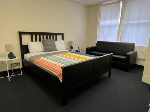 a bedroom with a large bed and a chair at Michie House in College Hill in Providence