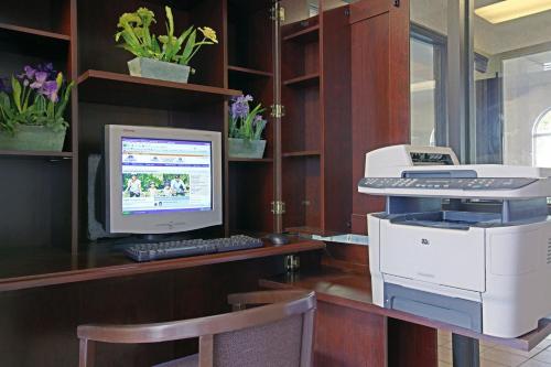 an office with a computer and a printer on a desk at Americas Best Value Inn and Suites Saint Charles in St. Charles