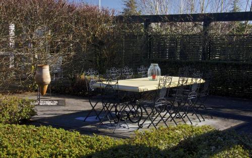 a table with chairs and a vase on top of it at Ruapehu Country Lodge in Ohakune