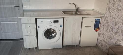 a kitchen with a washing machine and a sink at Mary's Cozy & Lovely studio on very quiet Khosharauli street in Tbilisi City