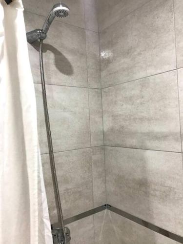 a shower with a shower curtain in a bathroom at Solo Se Trata De Vivir in Tandil
