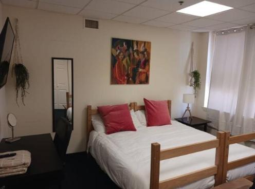 a bedroom with a large bed with red pillows at Michie House in College Hill in Providence