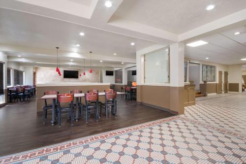 a large room with a bar and some tables and chairs at Comancheria Hotel & Convention Center in Lawton