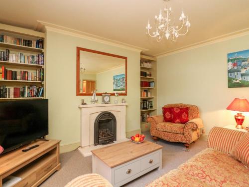 a living room with a fireplace and a television at Drake's Retreat in Plymouth