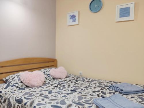 a bedroom with a bed with two stuffed animals on it at Ada Belgrade Apartment in Belgrade