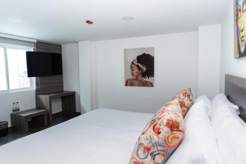 Postel nebo postele na pokoji v ubytování Hotel Qatar Cali