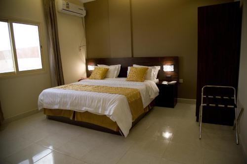 Un dormitorio con una cama grande y una ventana en Al Nakhlah Furnished Units, en Al Hofuf