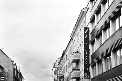 a black and white photo of a street with buildings at WALLYARD Stay in Berlin