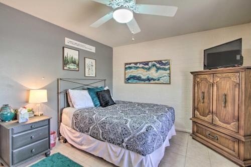 a bedroom with a bed and a flat screen tv at Golf Course and Pool Access Quaint Sun City Home in Sun City
