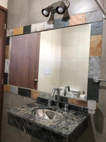 a bathroom with a sink and a mirror at La niña in San Juan
