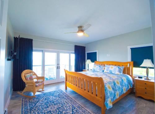 a bedroom with a wooden bed and a window at Sea Duck Cottage Main House in Jonesport