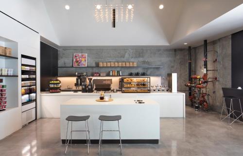 a kitchen with a white island and two bar stools at BEI San Francisco, Trademark Collection by Wyndham in San Francisco