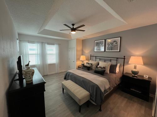 a bedroom with a bed and a ceiling fan at 3840 Supreme Villa 6Bd Private Pool and Game Room in Kissimmee