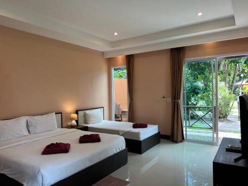 Ένα ή περισσότερα κρεβάτια σε δωμάτιο στο Ao Thong beach Resort