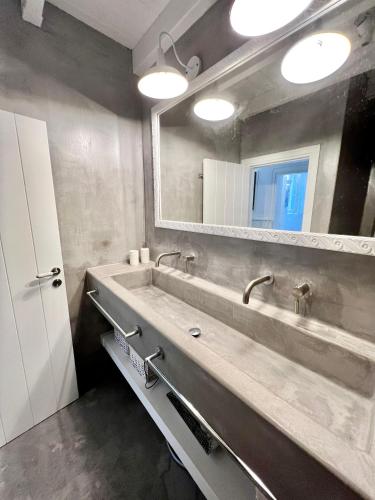 a bathroom with a large sink and a mirror at Aetheria traditional house in Koskinou