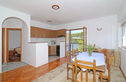 a kitchen and dining room with a table and chairs at Apartments by the sea Polace, Mljet - 613 in Polače
