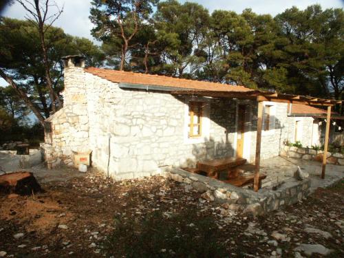 a small stone building with a roof on top at Apartments by the sea Pomena, Mljet - 614 in Pomena