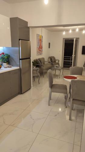 a large living room with chairs and a refrigerator at Apartments Barbie in Rethymno Town