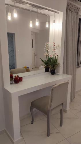 a white desk with a chair and a mirror at Apartments Barbie in Rethymno Town